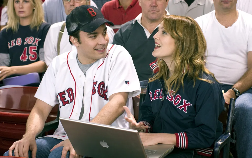 FP-125	Lindsey (Drew Barrymore) tries to juggle work and “fun” while attending a Red Sox game with boyfriend Ben (Jimmy Fallon). 
Photo Credit: Darren Michaels Major League Baseball trademarks and copyrights are used with permission of Major League Baseba