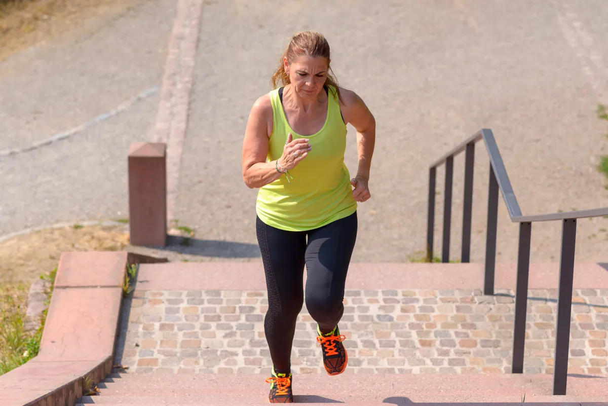 Csontritkulás elleni lépcsőzést végző középkorú nő.