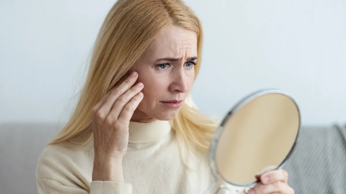Aged,Skin.,Mature,Sad,Woman,Looking,At,Her,Wrinkles,In