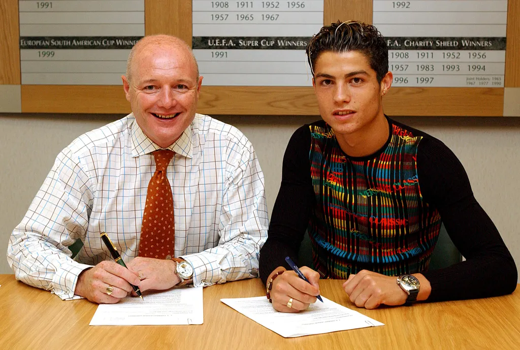 Chief Executive Peter Kenyon and Cristiano Ronaldo.               Cristiano Ronaldo Signs For Manchester United, Old Trafford, Manchester, 12/08/2003.