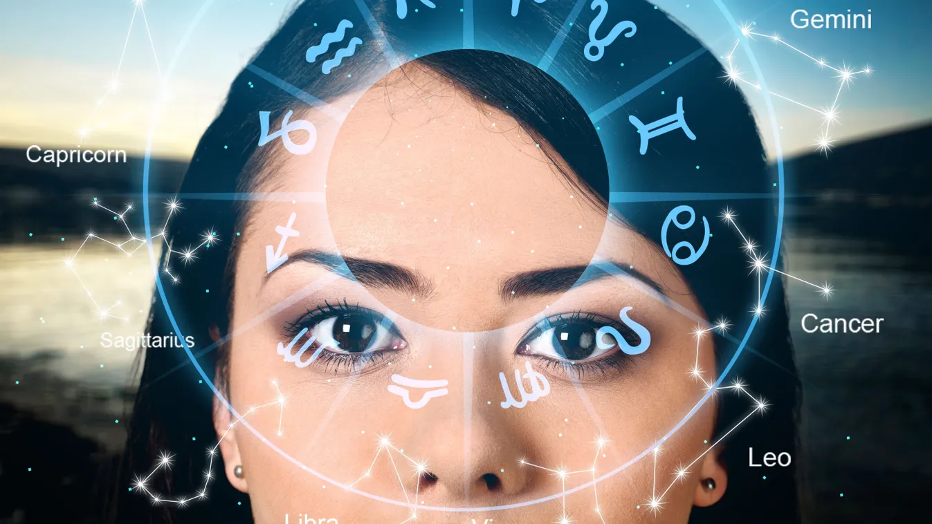 Barna szemű nő egy horoszkópban használt zodiákus kör mögött.