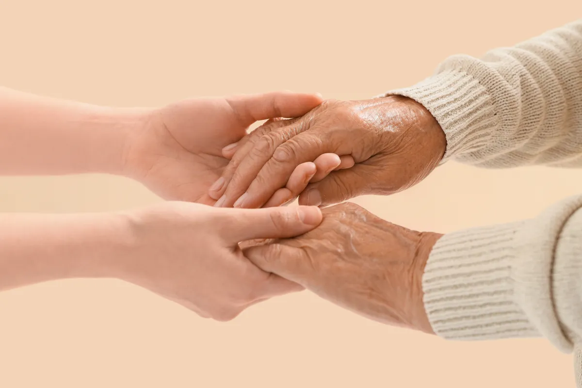 Longevity illusztrálása fiatalabb és idősebb kezekkel