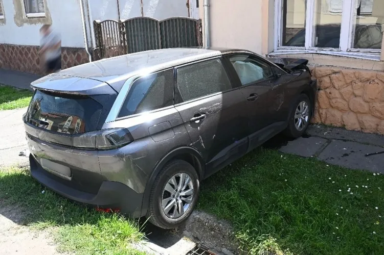 Falnak hajtott ölében gyermekével egy anyuka 