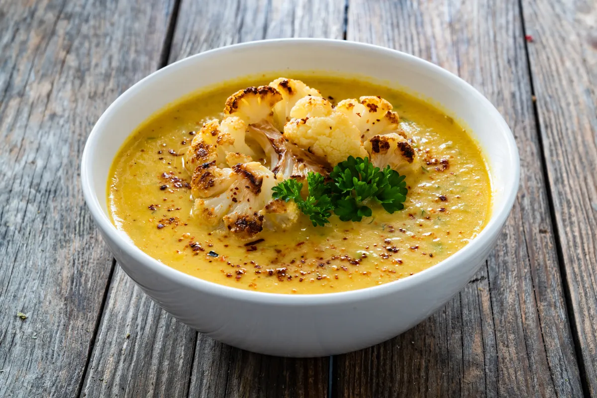 Karfiolleves fehér csészében feltéttel