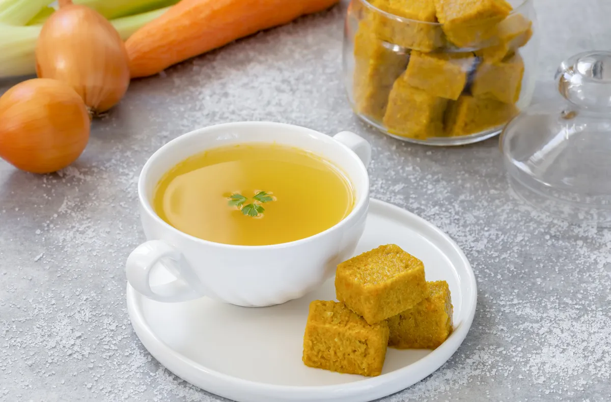 Házi leveskocka recept egy bögre leves mellett.