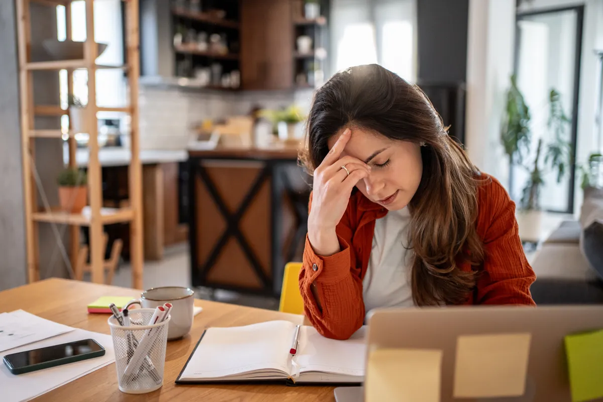MIndennapi rutinba az ünnepek után nehezen visszazökkenő fiatal üzletasszony az íróasztala mögött munka közben
