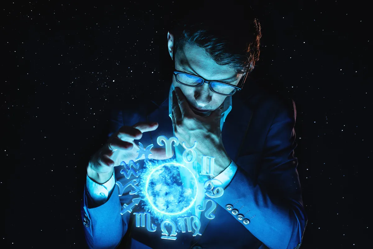 Horoszkópban használt zodiákus körből jósol egy szemüveges férfi.