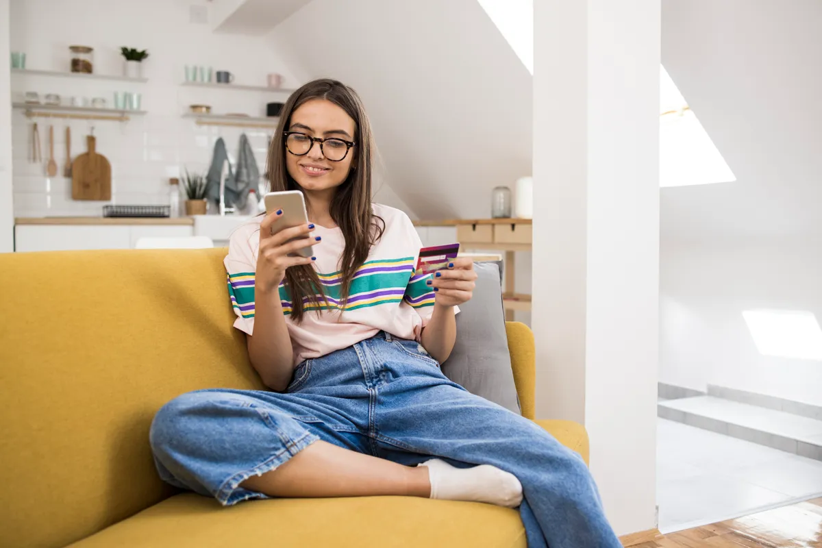 Teenage girl shopping online at home