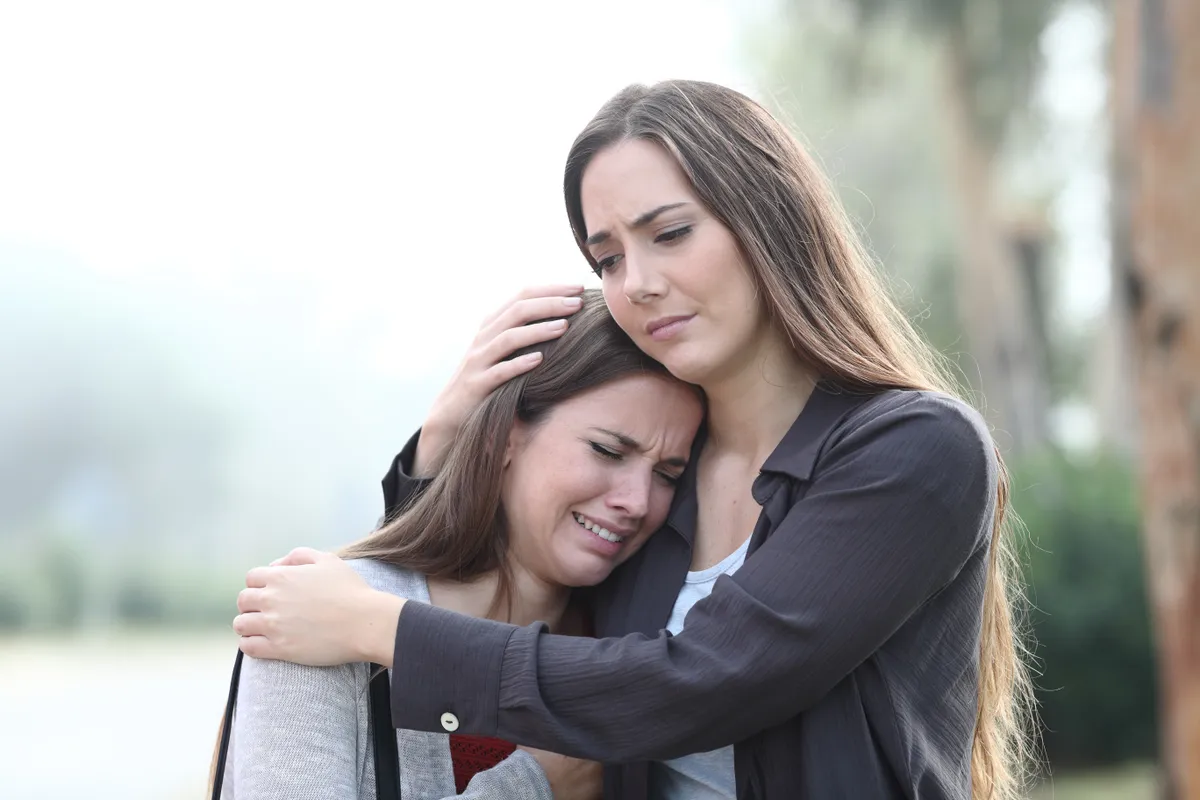 Sad,Woman,Crying,And,A,Friend,Comforting,Her,Standing,In